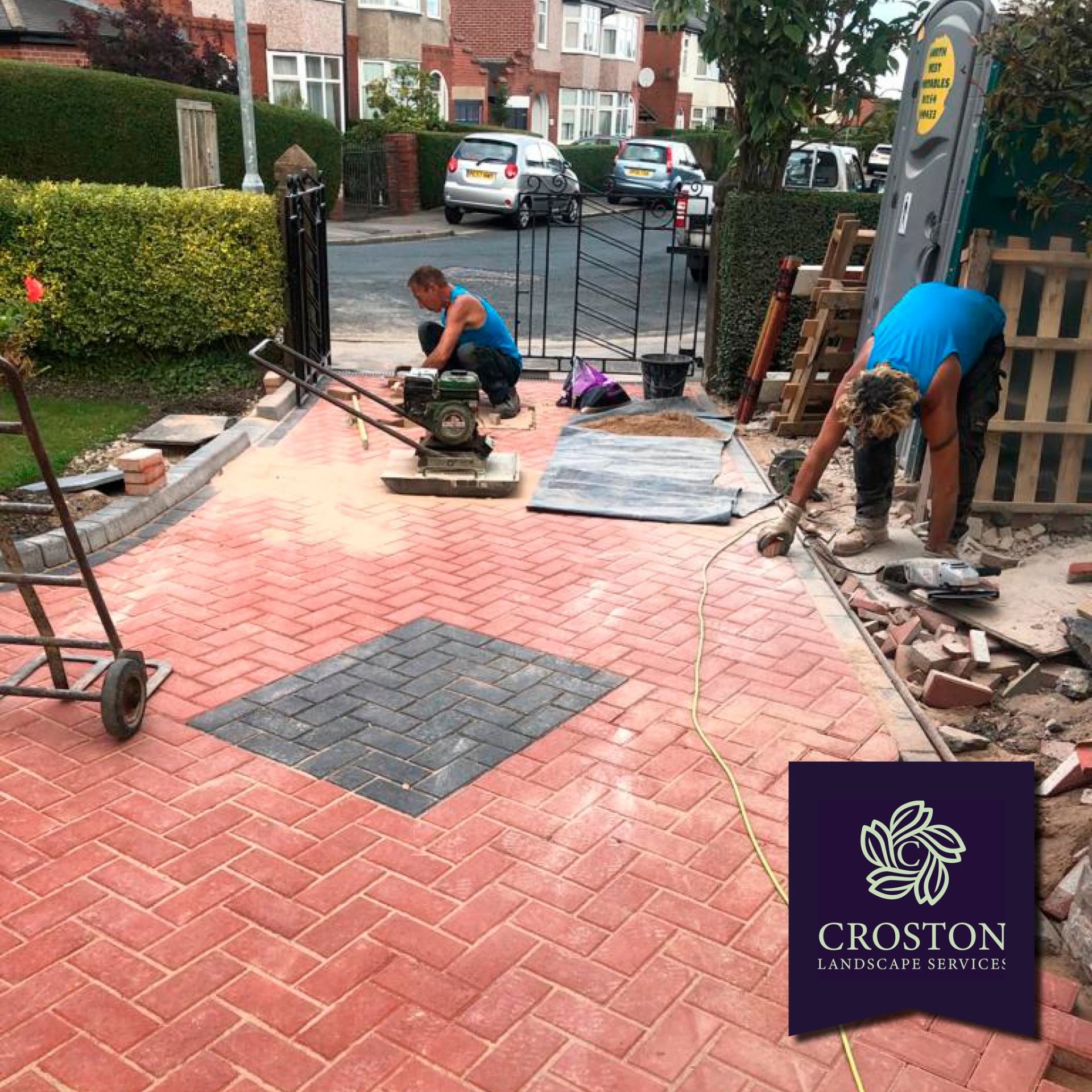 Croston team installing a red block-paved driveway with charcoal feature