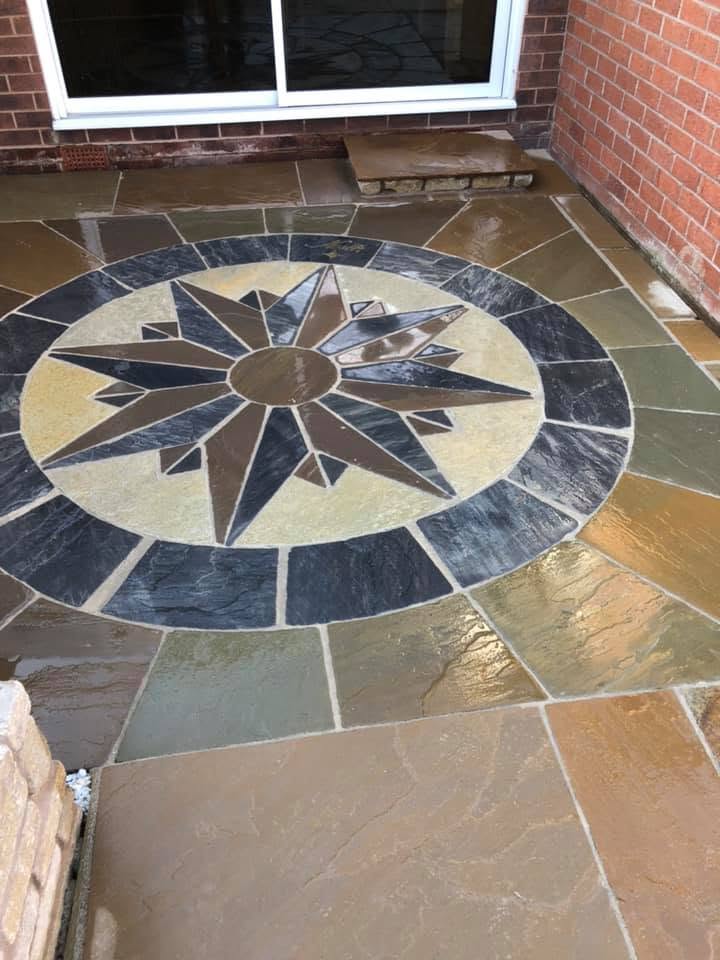 Multi-colour sandstone compass rose patio feature, freshly laid and sealed